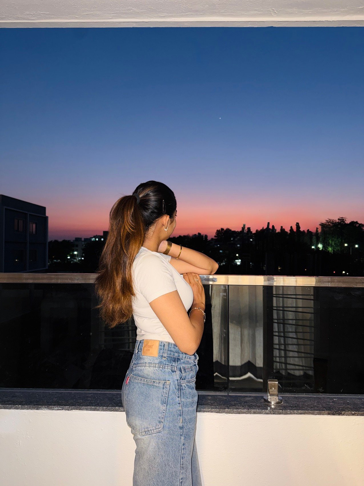 Rooftop sunset shoot in a white top and denim