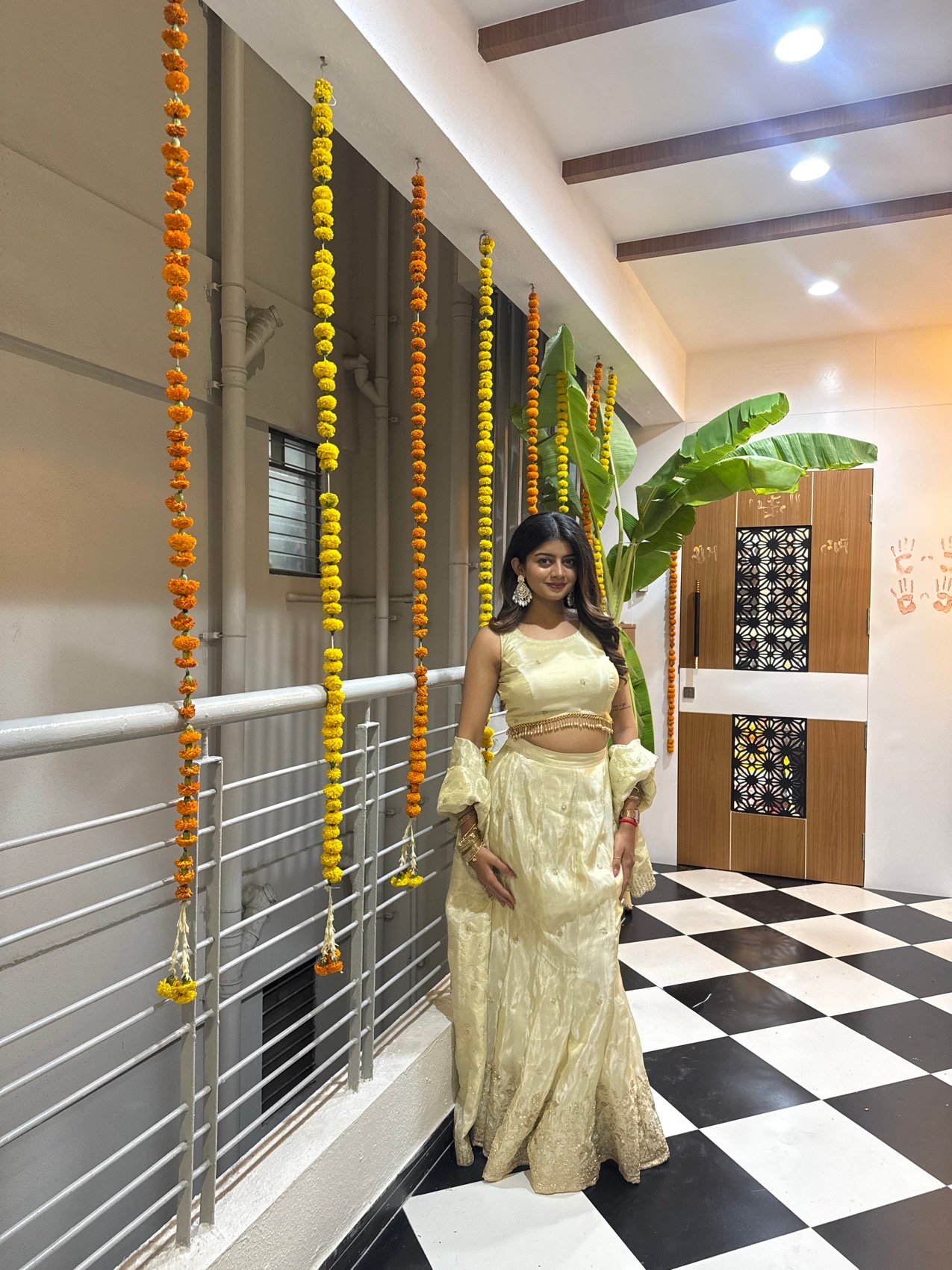 Festive golden lehenga shoot beside marigold garlands and a banana leaf